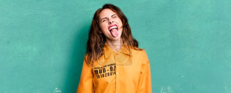 Photo for Hispanic pretty woman with cheerful and rebellious attitude, joking and sticking tongue out. guilt concept - Royalty Free Image