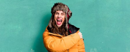 Photo for Hispanic pretty woman feeling happy and facing a challenge or celebrating. wearing an anorak. cold and winter concept - Royalty Free Image