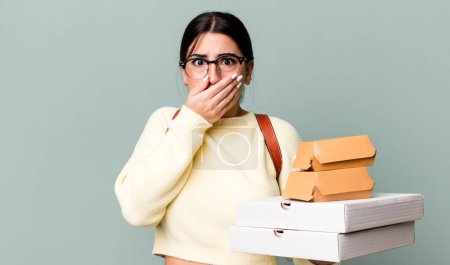 Téléchargez les photos : Covering mouth with hands with a shocked. fast food delivery or take away - en image libre de droit