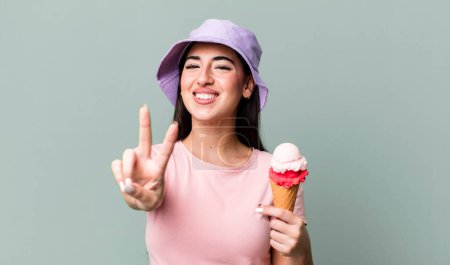 Foto de Smiling and looking happy, gesturing victory or peace. ice cream and summer concept - Imagen libre de derechos