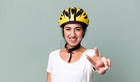 Photo for Smiling and looking happy, gesturing victory or peace. bike helmet concept - Royalty Free Image