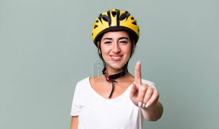 Photo for Smiling proudly and confidently making number one. bike helmet concept - Royalty Free Image