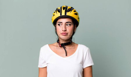 Foto de On profile view thinking, imagining or daydreaming. bike helmet concept - Imagen libre de derechos