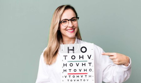 Photo for Pretty blonde woman with a optical vision test - Royalty Free Image