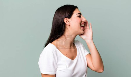 Photo for Profile view, looking happy and excited, shouting and calling to copy space on the side - Royalty Free Image