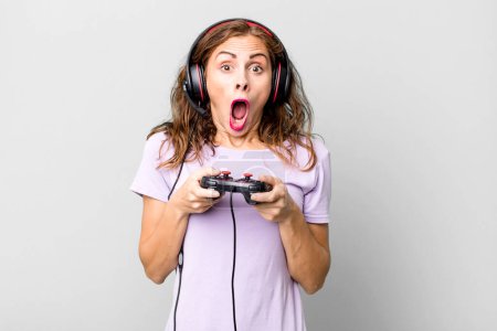 Photo for Hispanic pretty young woman playing with headphones and a control. gamer concept - Royalty Free Image