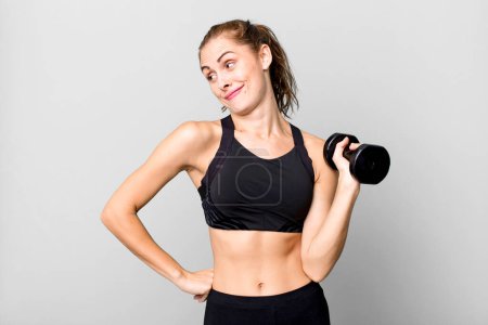 Photo for Hispanic pretty young woman lifting a dumbbell. fitness concept - Royalty Free Image