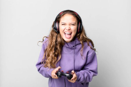 Photo for Hispanic pretty young woman playing a game with headphones and a control. gamer concept - Royalty Free Image