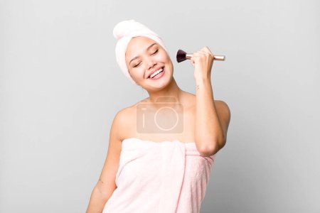 Foto de Hispanic pretty young woman wearing bathrobe. beauty and make up concept - Imagen libre de derechos