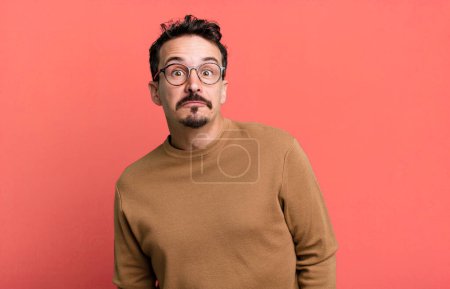 Photo for With a goofy, crazy, surprised expression, puffing cheeks, feeling stuffed, fat and full of food - Royalty Free Image