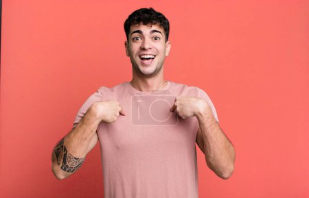 Photo for Man feeling happy, surprised and proud, pointing to self with an excited, amazed look - Royalty Free Image