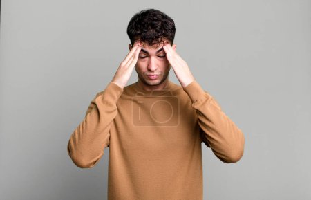 Photo for Man looking stressed and frustrated, working under pressure with a headache and troubled with problems - Royalty Free Image