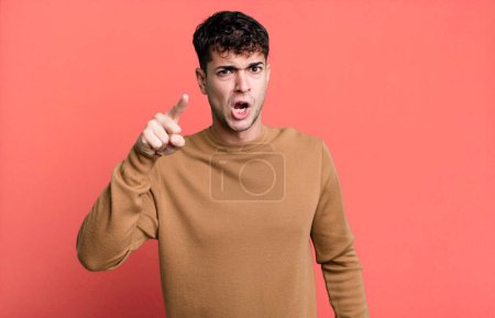 Photo for Man pointing at camera with an angry aggressive expression looking like a furious, crazy boss - Royalty Free Image
