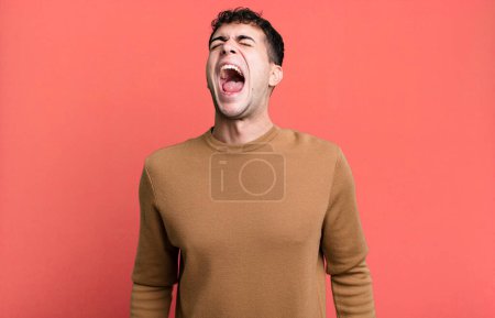 Photo for Man screaming furiously, shouting aggressively, looking stressed and angry - Royalty Free Image