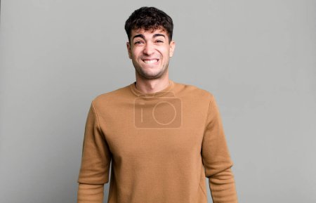 Photo for Man looking puzzled and confused, biting lip with a nervous gesture, not knowing the answer to the problem - Royalty Free Image
