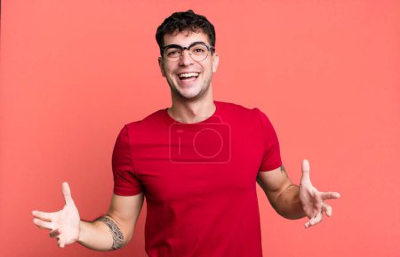 Photo for Man looking happy, arrogant, proud and self satisfied, feeling like a number one - Royalty Free Image