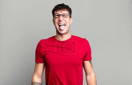 Photo for With cheerful, carefree, rebellious attitude, joking and sticking tongue out, having fun - Royalty Free Image