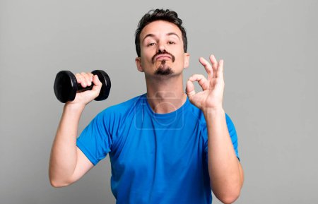 Photo for Adult man training and lifting a dumbbell - Royalty Free Image