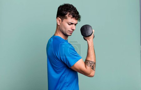 Photo for Adult man lifting a dumbbell and fitness concept - Royalty Free Image
