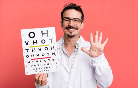 Foto de Adult man smiling and looking friendly, showing number five. optical vision test concept - Imagen libre de derechos