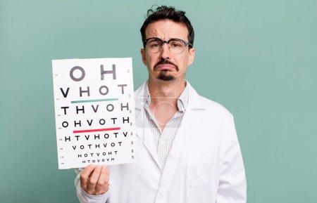 Téléchargez les photos : Adult man feeling sad and whiney with an unhappy look and crying. optical vision test concept - en image libre de droit
