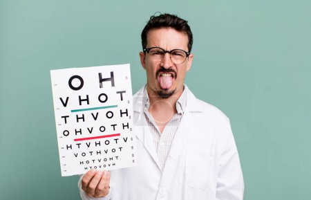 Foto de Adult man feeling disgusted and irritated and tongue out. optical vision test concept - Imagen libre de derechos