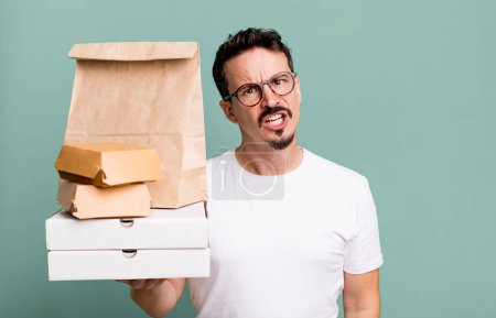 Photo for Adult man feeling puzzled and confused. fast food delivery and take away concept - Royalty Free Image
