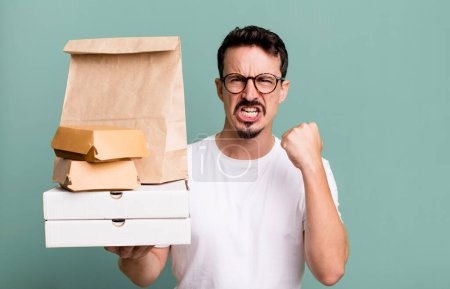 Photo for Adult man shouting aggressively with an angry expression. fast food delivery and take away concept - Royalty Free Image