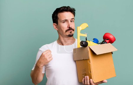 Photo for Adult man looking arrogant, successful, positive and proud. with a toolbox. handyman concept - Royalty Free Image