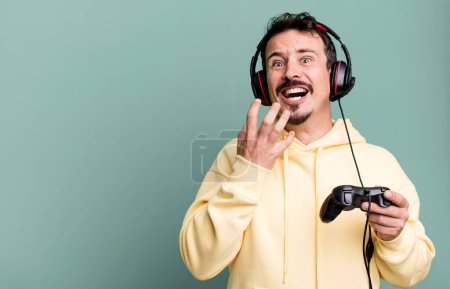 Photo for Adult man looking desperate, frustrated and stressed with headset and a control. gamer concept - Royalty Free Image