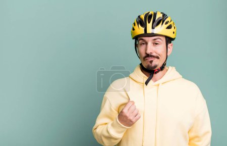 Photo for Adult man looking arrogant, successful, positive and proud. bike helmet and bicycle concept - Royalty Free Image