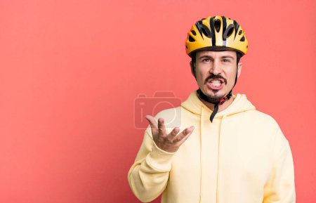 Photo for Adult man looking angry, annoyed and frustrated. bike helmet and bicycle concept - Royalty Free Image