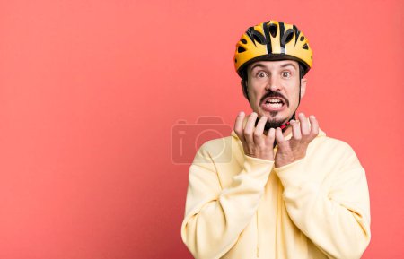 Photo for Adult man looking desperate, frustrated and stressed. bike helmet and bicycle concept - Royalty Free Image