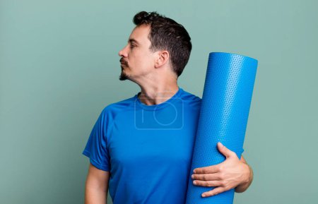 Photo for Adult man on profile view thinking, imagining or daydreaming. fitness and yoga concept - Royalty Free Image
