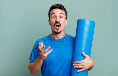 Photo for Adult man amazed, shocked and astonished with an unbelievable surprise. fitness and yoga concept - Royalty Free Image