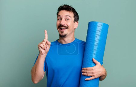 Photo for Adult man feeling like a happy and excited genius after realizing an idea. fitness and yoga concept - Royalty Free Image
