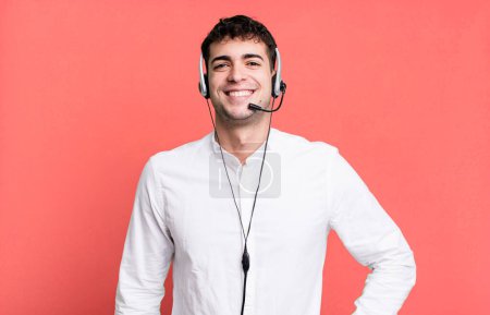 Photo for Adult man smiling happily with a hand on hip and confident with headset. telemarketer operator concept - Royalty Free Image