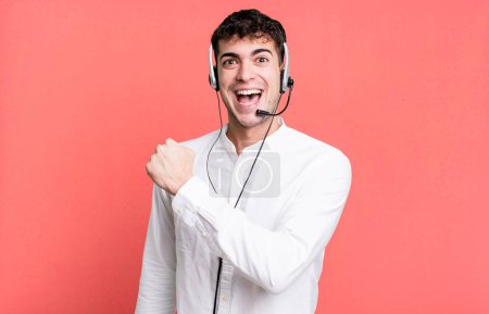 Photo for Adult man feeling happy and facing a challenge or celebrating with headset. telemarketer operator concept - Royalty Free Image