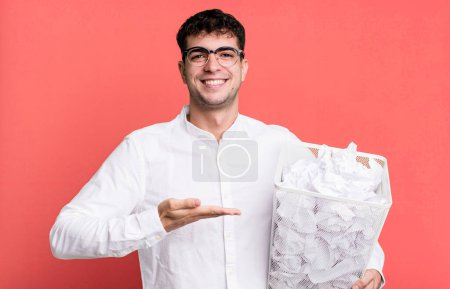 Photo for Adult man smiling cheerfully, feeling happy and showing a concept. paper balls mistakes trash - Royalty Free Image
