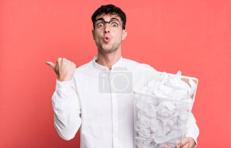 Photo for Adult man looking astonished in disbelief. paper balls mistakes trash - Royalty Free Image