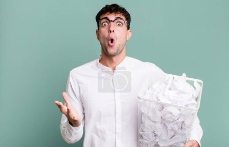 Foto de Hombre adulto sorprendido, sorprendido y asombrado con una sorpresa increíble. bolas de papel errores basura - Imagen libre de derechos