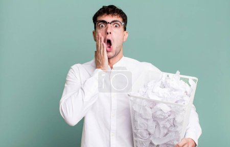 Photo for Adult man feeling shocked and scared. paper balls mistakes trash - Royalty Free Image