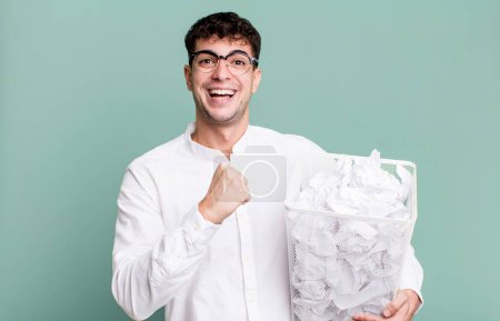 Photo for Adult man feeling happy and facing a challenge or celebrating. paper balls mistakes trash - Royalty Free Image