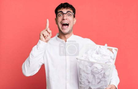 Photo for Adult man feeling like a happy and excited genius after realizing an idea. paper balls mistakes trash - Royalty Free Image
