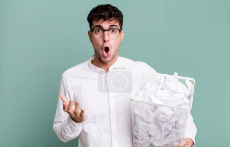Photo for Adult man feeling extremely shocked and surprised. paper balls mistakes trash - Royalty Free Image