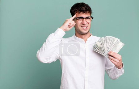 Photo for Adult man feeling confused and puzzled, showing you are insane. dollar banknotes concept - Royalty Free Image