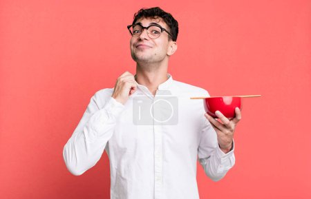 Photo for Adult man looking arrogant, successful, positive and proud holding a ramen noodles bowl - Royalty Free Image