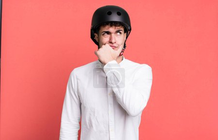 Photo for Adult man thinking, feeling doubtful and confused. city motorbike rider concept - Royalty Free Image