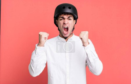 Photo for Adult man shouting aggressively with an angry expression. city motorbike rider concept - Royalty Free Image