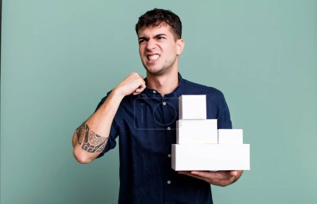 Photo for Adult man feeling stressed, anxious, tired and frustrated with blank products packages - Royalty Free Image